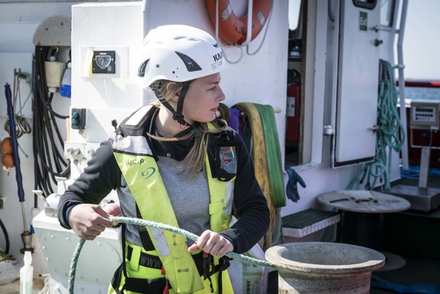 Employee holds a rope at a facility